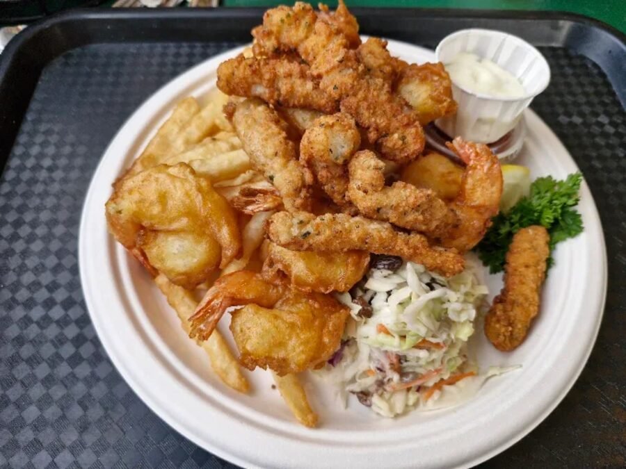 A tray of fried shrimp, prawns, fries and slaw from the Sea Harvest kitchen
