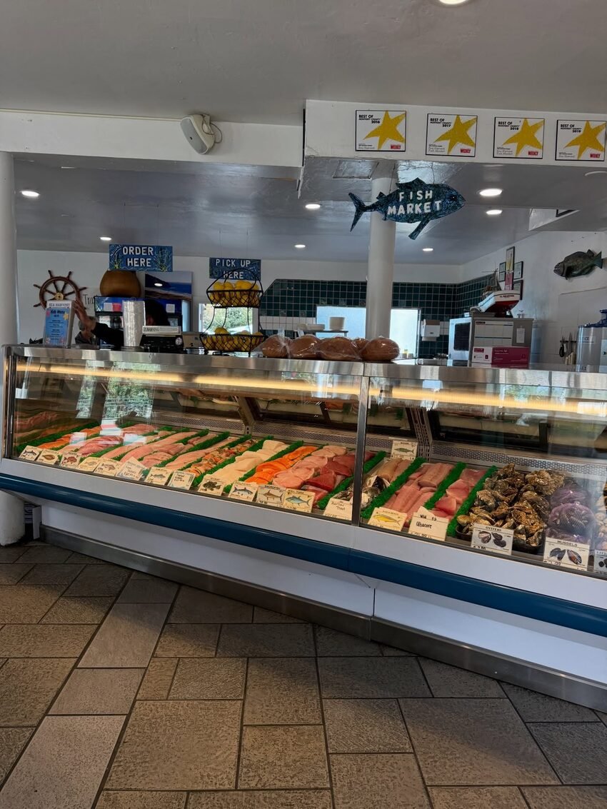 The Sea Harvest fish market case, stocked with fresh fillets and oysters under the Best of Monterey County awards